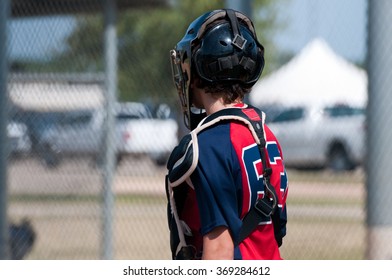 Young Teen Baseball Catcher From Behind During Game.