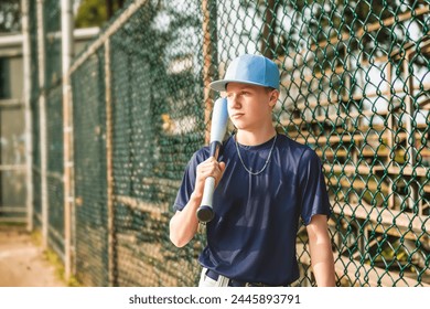 A Young teen boy play baseball on a playground - Powered by Shutterstock