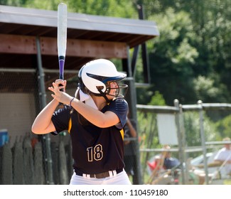 Young Teen Girl Playing Softball In Organized Game