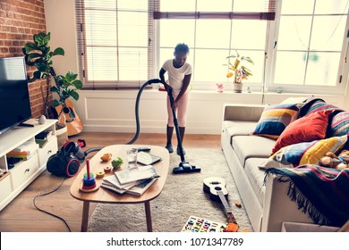 Young Teen Girl Vacuuming Up The House