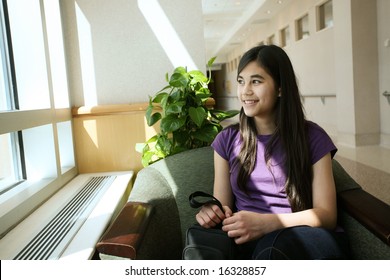 Young teen girl waiting in doctor's waiting room - Powered by Shutterstock