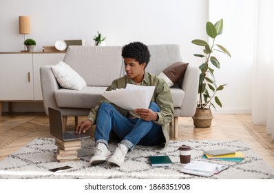 Young Teen Guy With Educational Materials, Books And Laptop Computer Working On Cousework Or School Project At Home. College Student Studying Online, Writing Essay Or Graduation Thesis