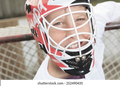 A young teen hockey goaler outside in the arena