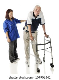 A young teen volunteer keeping an elderly man secure as he ambulates with his walker.  On a white background.