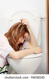 Young Teen Woman Vomiting In Toilet