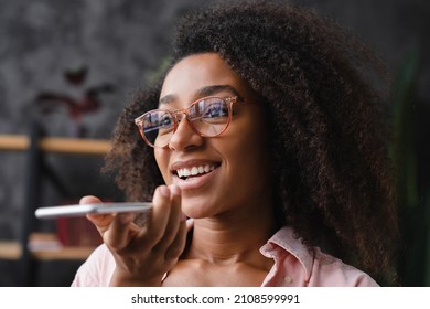 Young Teenage African Girl Schoolgirl Student Recording Voice Message On Smart Phone Cellphone, Talking With Colleagues, Friends Online