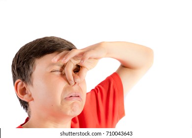 Young Teenage Boy Isolated On A White Background Holding His Nose