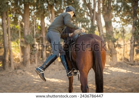 young teenage boy riding a horse
