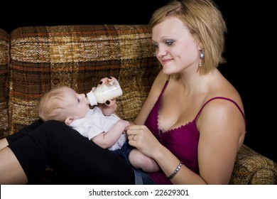 A Young Teenage Girl Babysitting A Baby Boy.