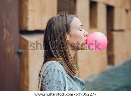 Similar – Image, Stock Photo Young teenage girl blowing pink bubble gum