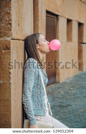 Similar – Image, Stock Photo Young teenage girl blowing pink bubble gum