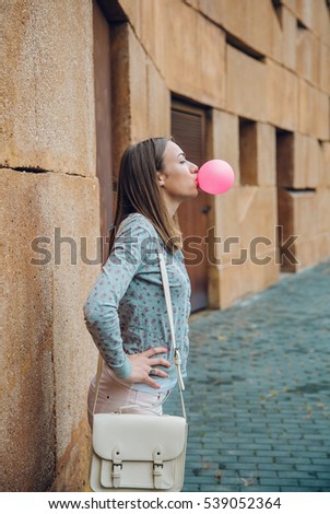 Similar – Image, Stock Photo Young teenage girl blowing pink bubble gum