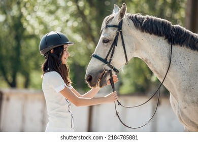 Young Teenage Girl Equestrian Having Fun With Her Favorite Horse. Dressage Outfit