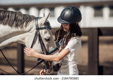 Young Teenage Girl Equestrian Having Fun With Her Favorite Horse. Dressage Outfit