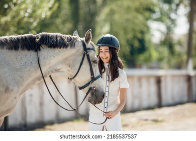 Young Teenage Girl Equestrian Having Fun With Her Favorite Horse. Dressage Outfit