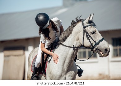 Young Teenage Girl Equestrian Showing Love And Care To Her Favorite Horse. Dressage Outfit