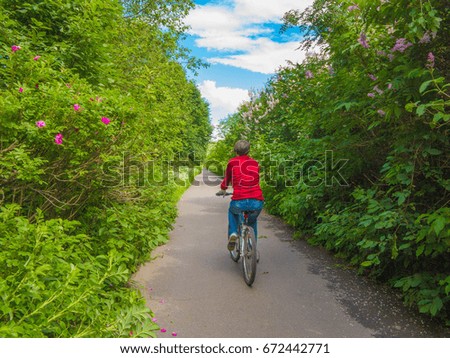 Similar – Radfahrer auf Waldweg