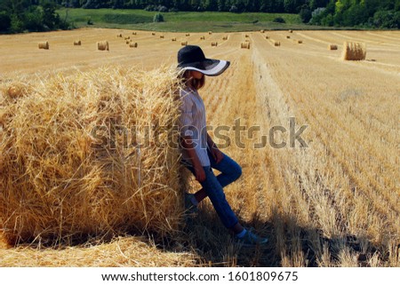 Woman alone in a field of wheat