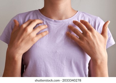 Young teenage girl practicing EFT or emotional freedom technique - tapping on the collarbone point