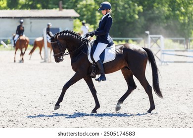 Young teenage girl riding horse before her dressage test in equestrian competition. - Powered by Shutterstock