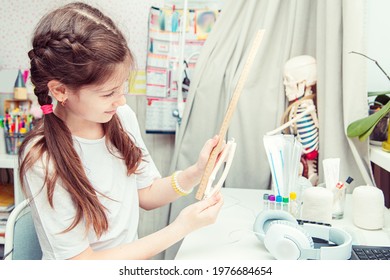 Young Teenage Girl Studying Human Anatomy At Home. She Measures The Bone Of The Arm. Unusual Hobby. 