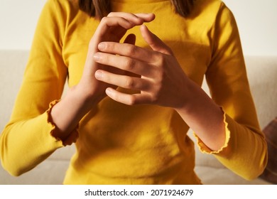 Young teenage girl top practicing EFT or emotional freedom technique - tapping on side of the hand - Shutterstock ID 2071924679