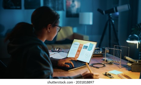 Young Teenage Multiethnic Schoolgirl Is Studying Science Topic About Robotics At Home. Girl Is Working On Homework For School. Young Female Reading Research Articles About Her Hobby. Education Concept