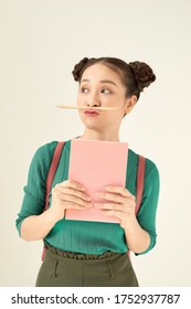 Young Teenage Student Freaking Out And Holding Her Pencil Between Nose And Lips As Moustache Looking Funny And Naughty