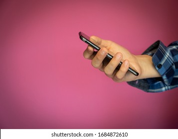 Young Teenager Boy Hand Using Mobile Phone Or Smartphone On Color Wall Background