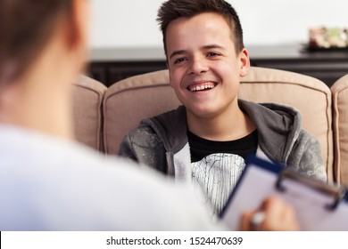 Young teenager boy laughing at counseling professional in foreground, not taking it seriously, deny and underrate the importance - close up