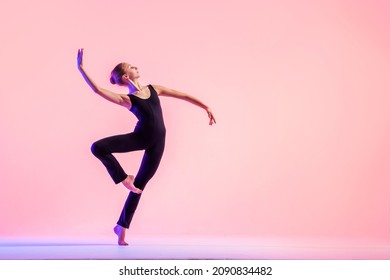 Young teenager dancer dancing on red studio background. Ballet, dance, art, modernity, choreography concept - Powered by Shutterstock