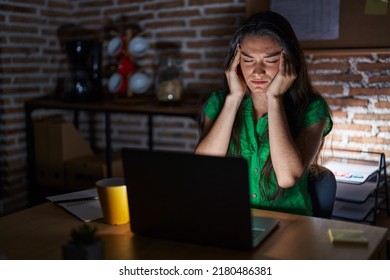 Young Teenager Girl Working At The Office At Night With Hand On Head For Pain In Head Because Stress. Suffering Migraine. 