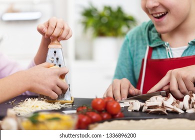 Young teenager hands prepare a pizza in the kitchen - with the ingredients around, close up - Powered by Shutterstock