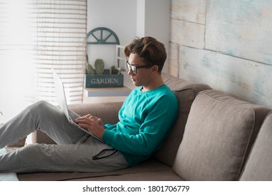 Young Teenager Male Student At Home Doing Online Classes Lessons With Computer Laptop Internet Connected Technology - School And Study Concept In Covid-19 Coronavirus Lockdown Time