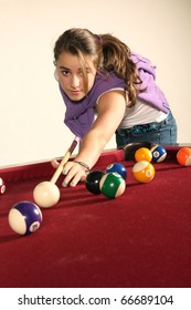 Young Teenager Playing Pool On A Red Table