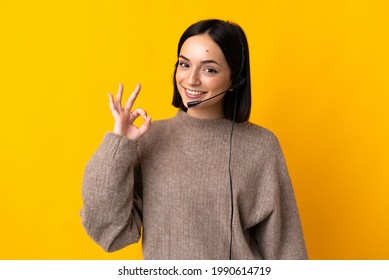 Young Telemarketer Woman Isolated On Yellow Background Showing Ok Sign With Fingers