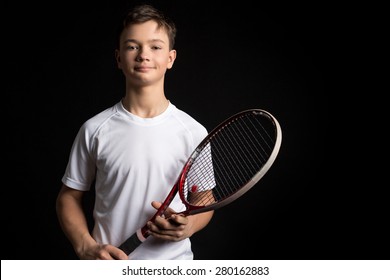 Young tennis player on black background. Studio shot
