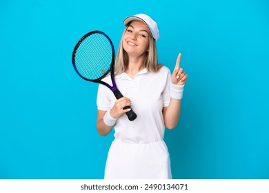 Young tennis player Romanian woman isolated on blue background showing and lifting a finger in sign of the best - Powered by Shutterstock