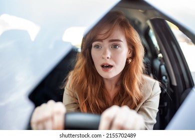 Young terrified woman driving and having a car accident. adult woman driving and looking scared and surprised at the road in front of her. Woman in Car Crash