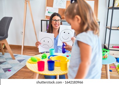 Young therapist woman speaking and treating child, counselor and behaviour correction at pedagogue payroom showing happy and sad faces