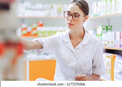 A Young Thin Brown-haired Girl With Glasses,dressed In A Lab Coa