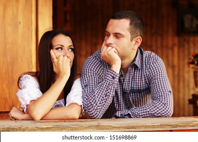 Young Thinking Couple Looking At Each Other