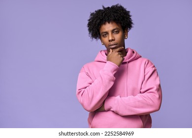 Young thoughtful African American teen guy thinking holding hand on chin isolated on purple background. Ethnic generation z teenager student choosing, making decision, feeling doubt, having question. - Powered by Shutterstock