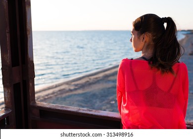 Young thoughtful charming woman enjoying beautiful landscape  in summer day while standing against blue sky and calm sea background with copy space area for your text message or advertising content - Powered by Shutterstock