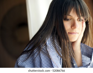 Young Thoughtful Woman Looking Outside