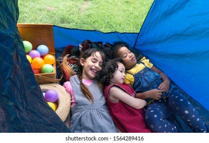 Young Three Cute Kid Girls (American,African,Asian) Are Smile And Sleeping In Tent Or Camp At Park,picnic Time,happy Time Camping