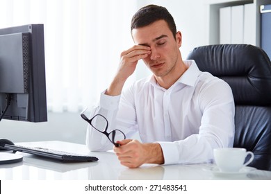 Young Tired Businessman Rubbing His Eye