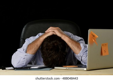 Young Tired Businessman Suffering Work Stress Wasted And Worried Busy In Office Late At Night With Laptop Computer In Business Problem And Mess Concept Isolated On Black Background