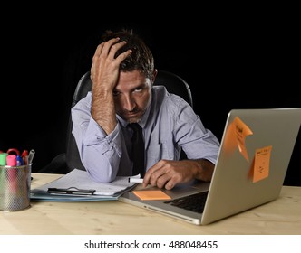 Young Tired Businessman Suffering Work Stress Wasted And Worried Busy In Office Late At Night With Laptop Computer In Business Problem And Mess Concept Isolated On Black Background