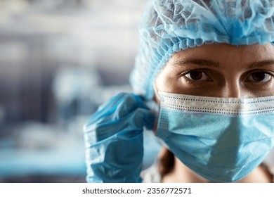 young tired doctor on rurse taking off medical face mask after hard working day in clinic.  Protection against infections - Powered by Shutterstock